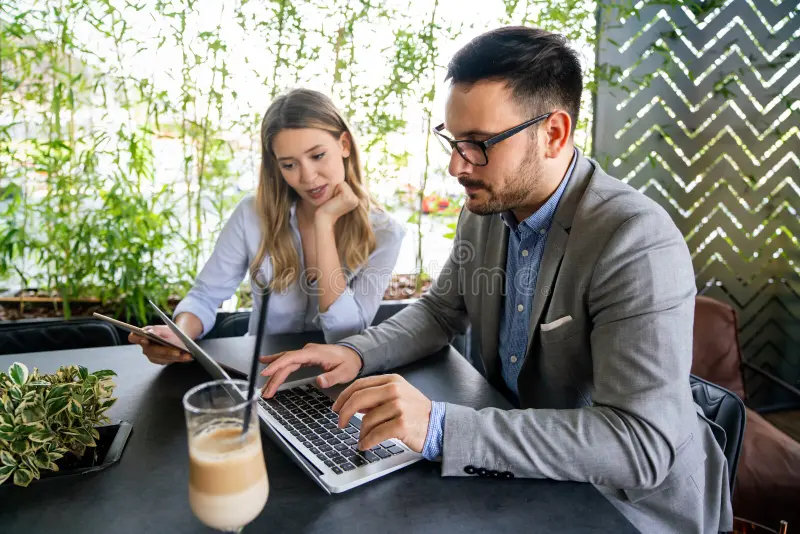 Two professionals engaged in a feedback conversation, demonstrating coaching skills and emotional intelligence at work